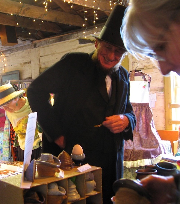 Lincoln shopping at muddy mountain pottery show booth